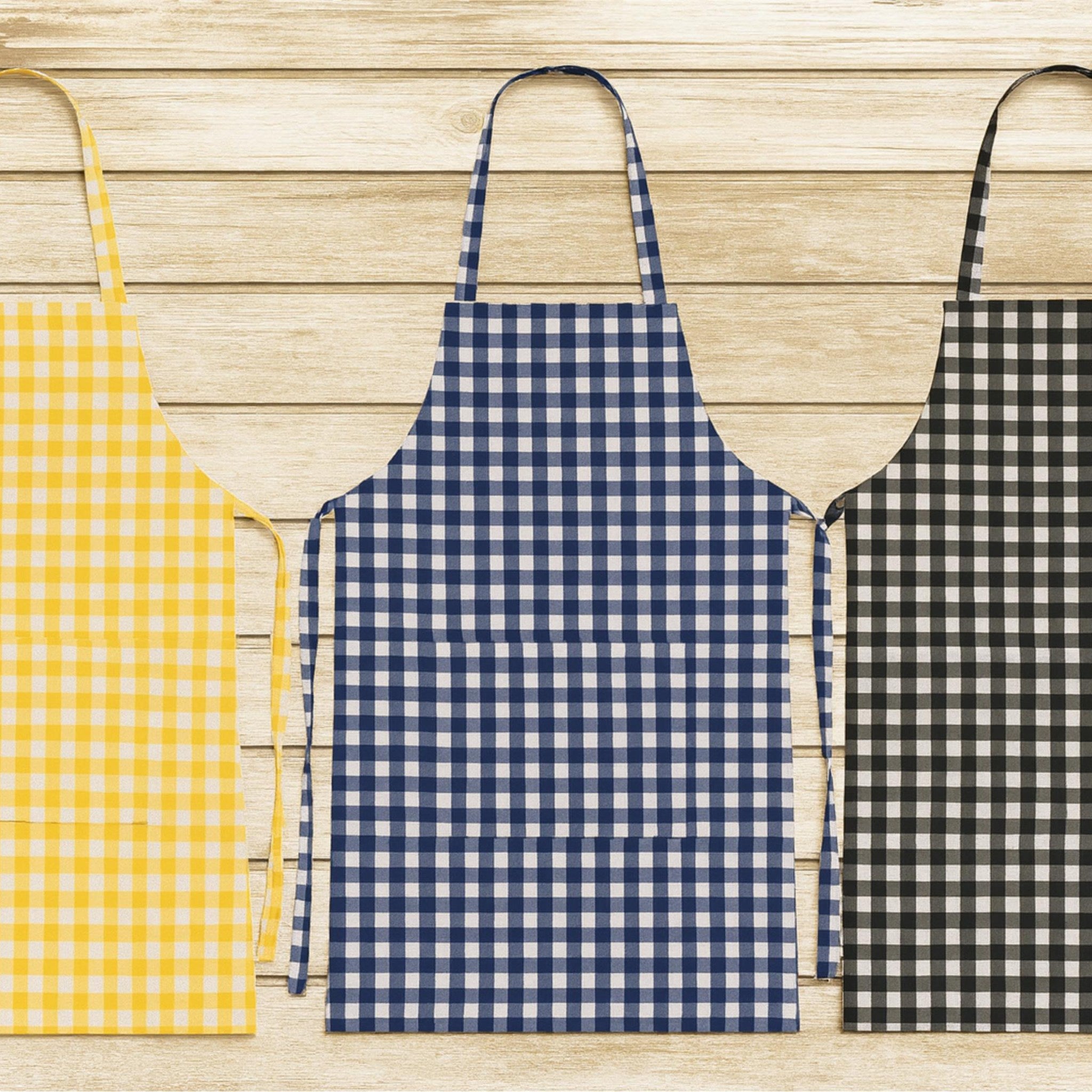 Three gingham aprons in yellow, navy and black