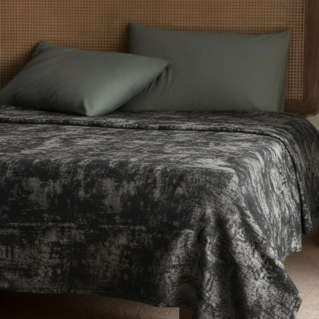 Gray and copper velvet bedspread on a bed