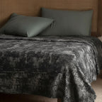 Gray and copper velvet bedspread on a bed