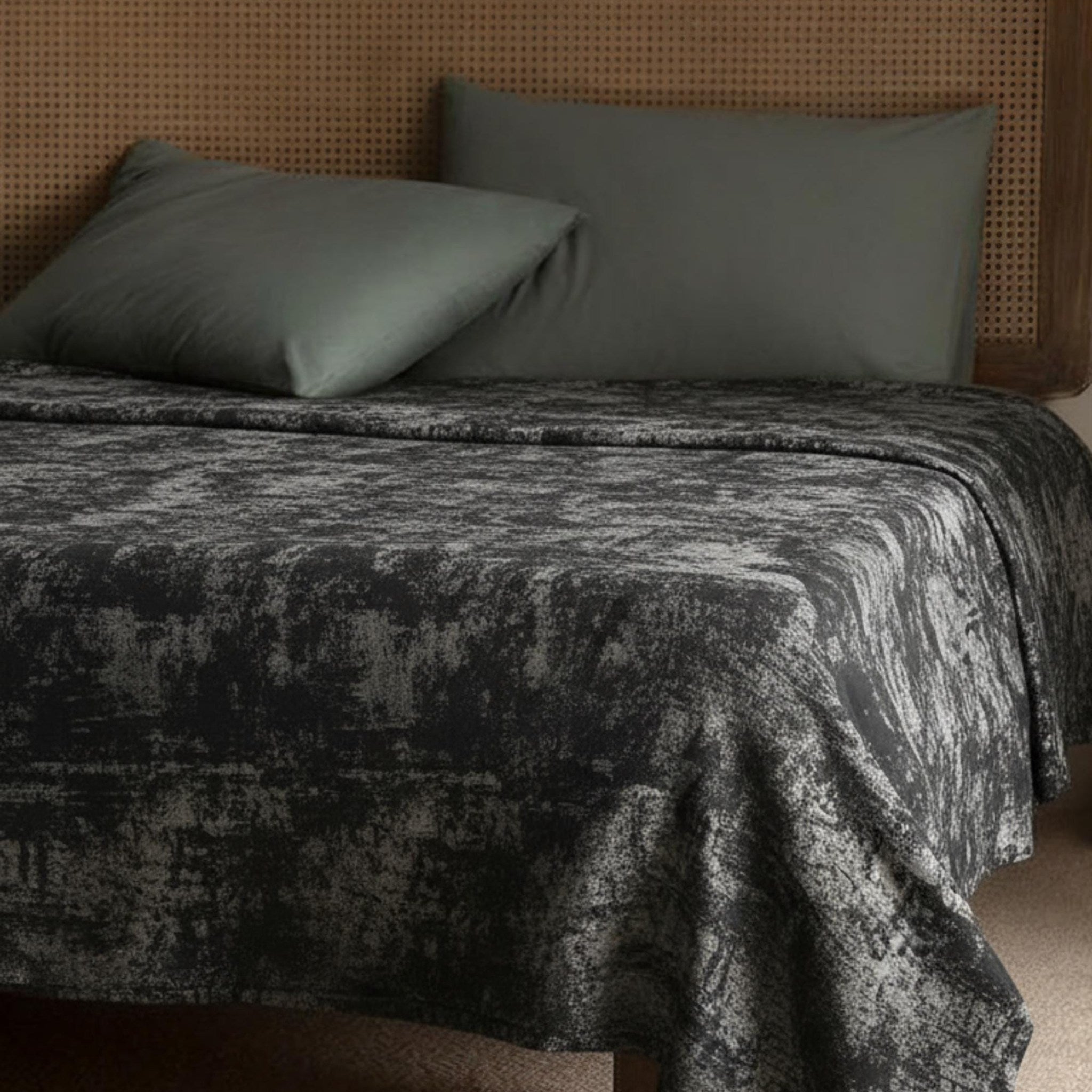 Gray and copper velvet bedspread on a bed