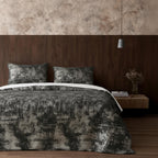 Gray velvet bedspread in dark bedroom