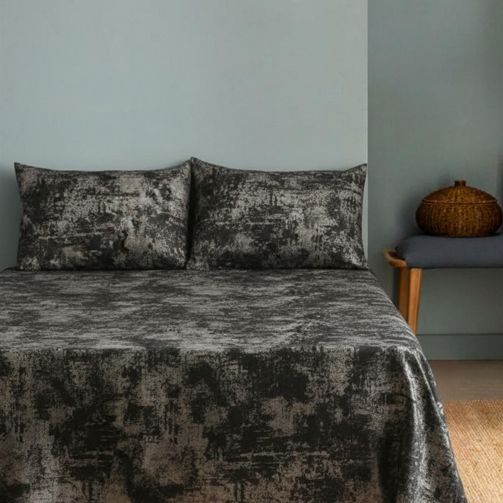 Velvet bedspread on bed with blue wall