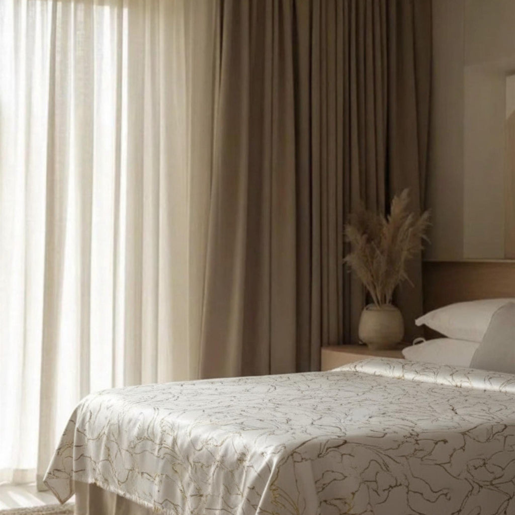 Cream bedspread by the window