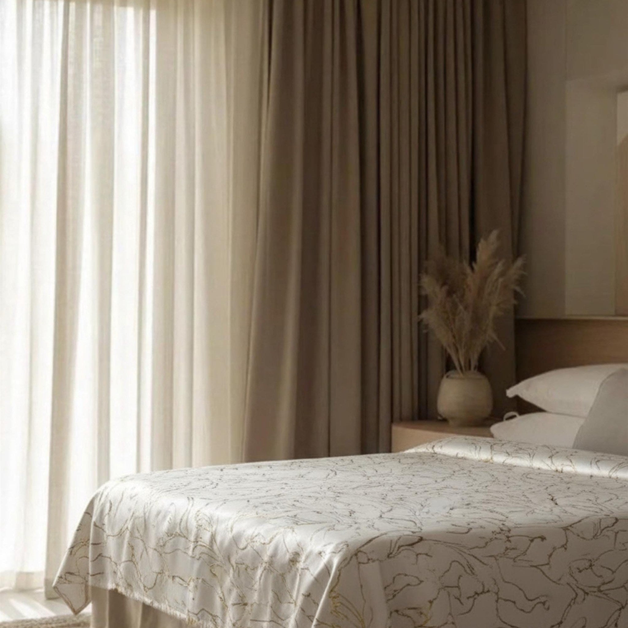 Cream bedspread by the window