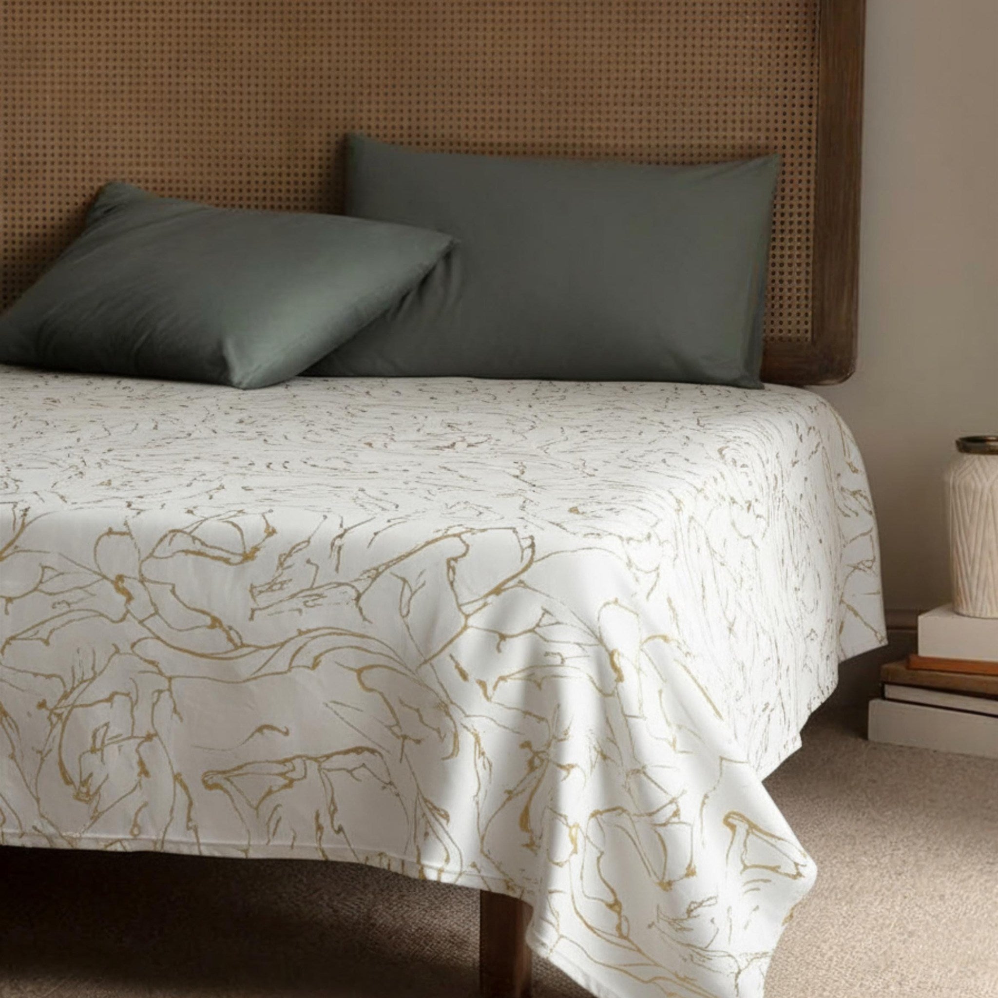 Cream gold bedspread with green pillows