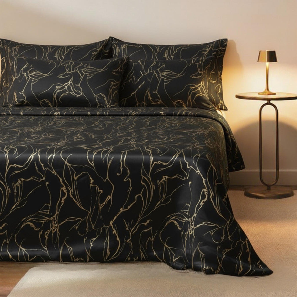 Black and gold swirl velvet bedspread on a bed