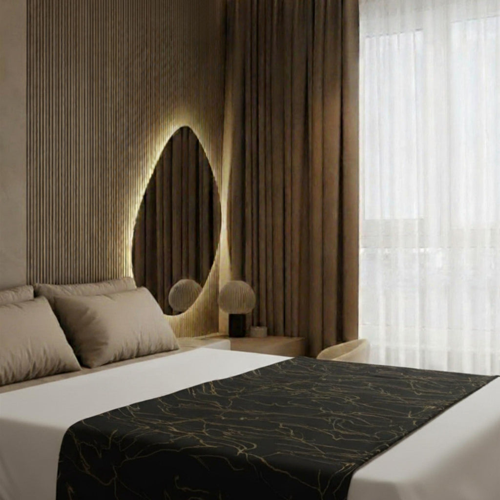 Black bedspread in warm-lit bedroom