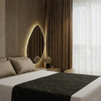Black bedspread in warm-lit bedroom