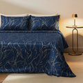 Navy and gold swirl velvet bedspread on a bed