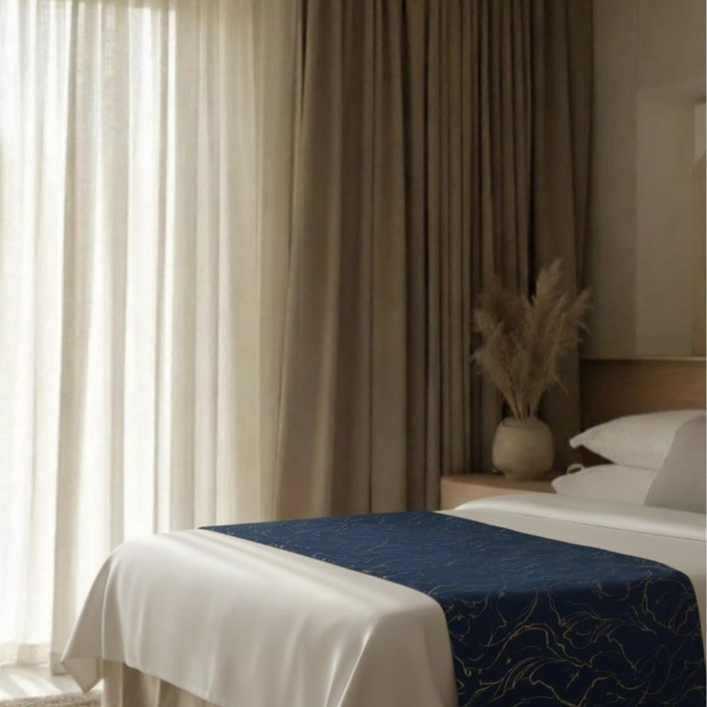 Navy bedspread in warm-lit bedroom