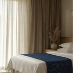 Navy bedspread in warm-lit bedroom