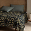Black and copper velvet bedspread on a bed