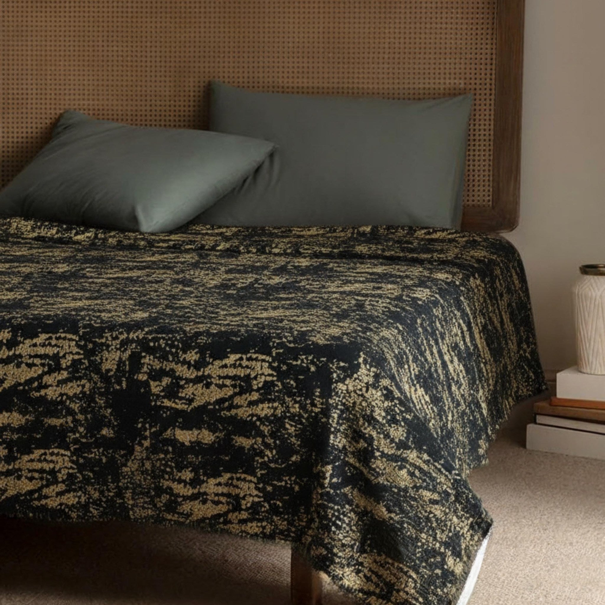 Black and copper velvet bedspread on a bed
