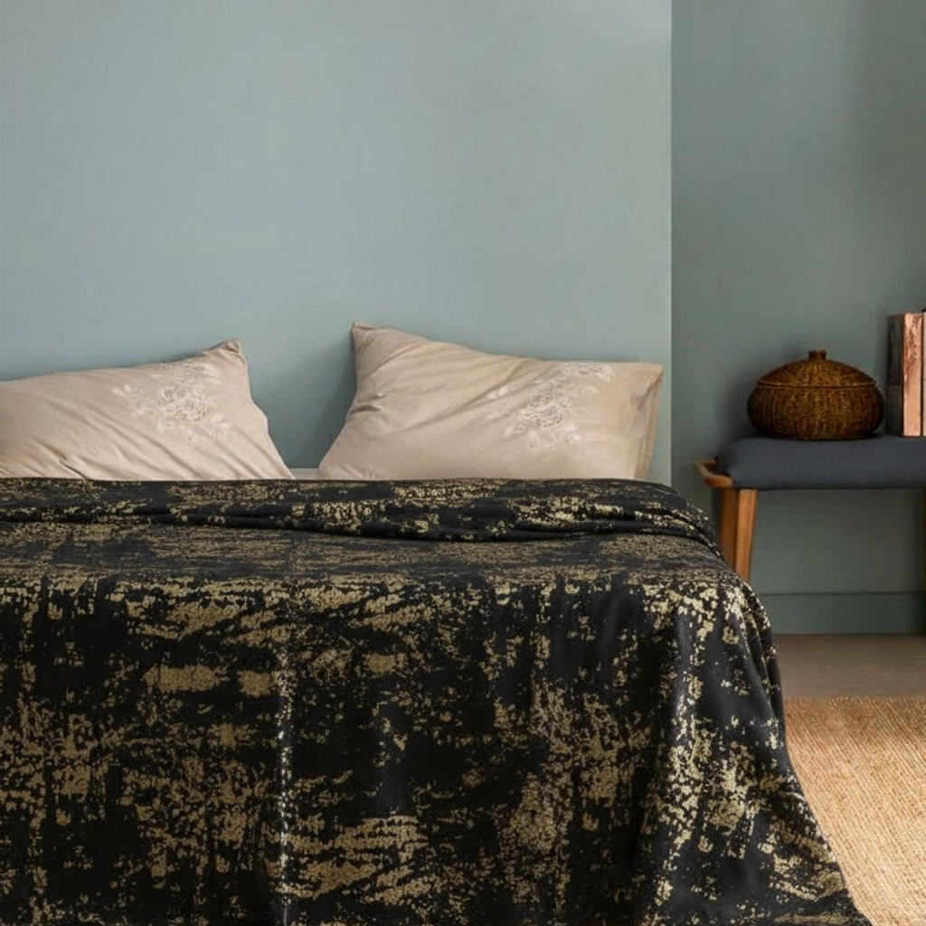Black bedspread in light blue bedroom