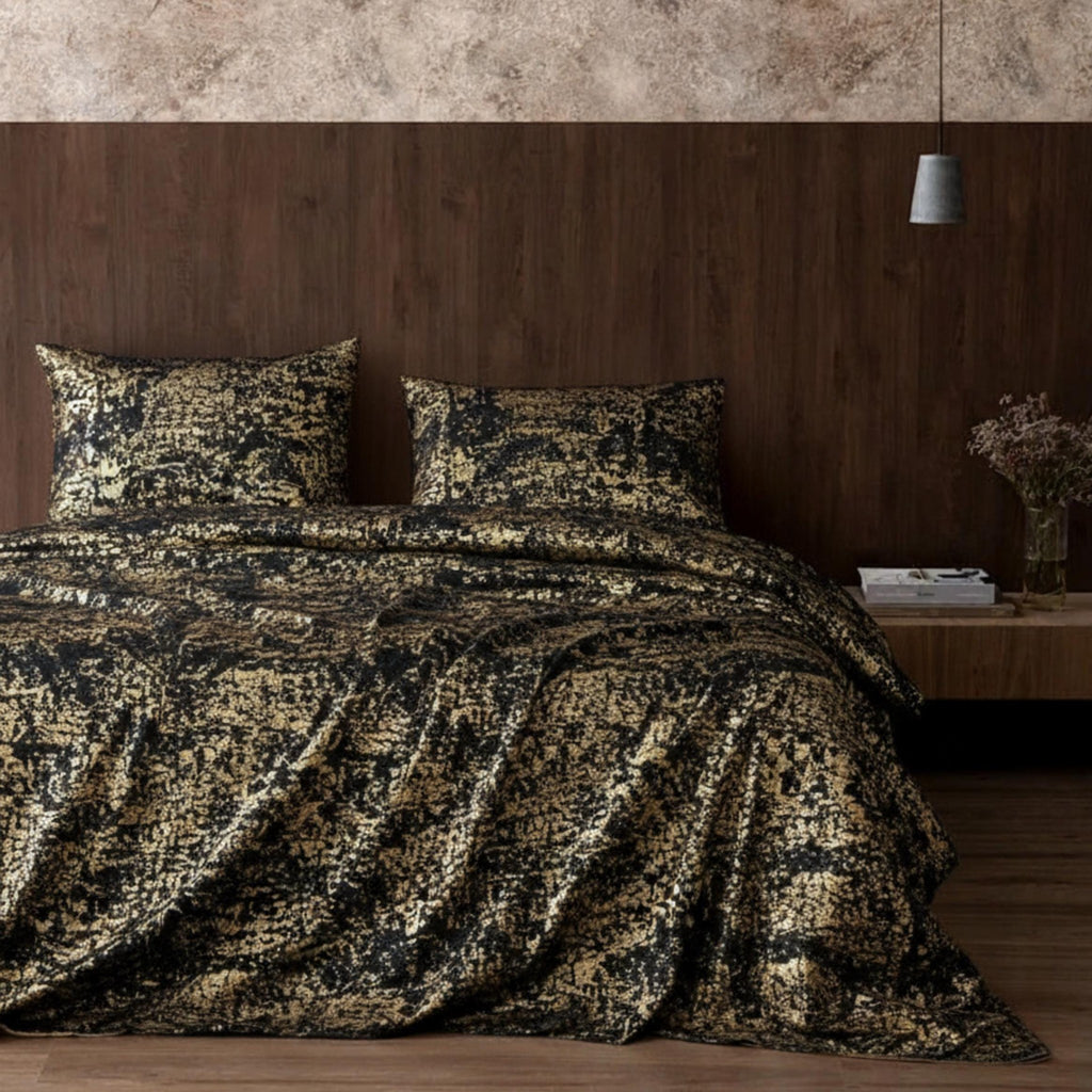 Black copper bedspread in dark bedroom