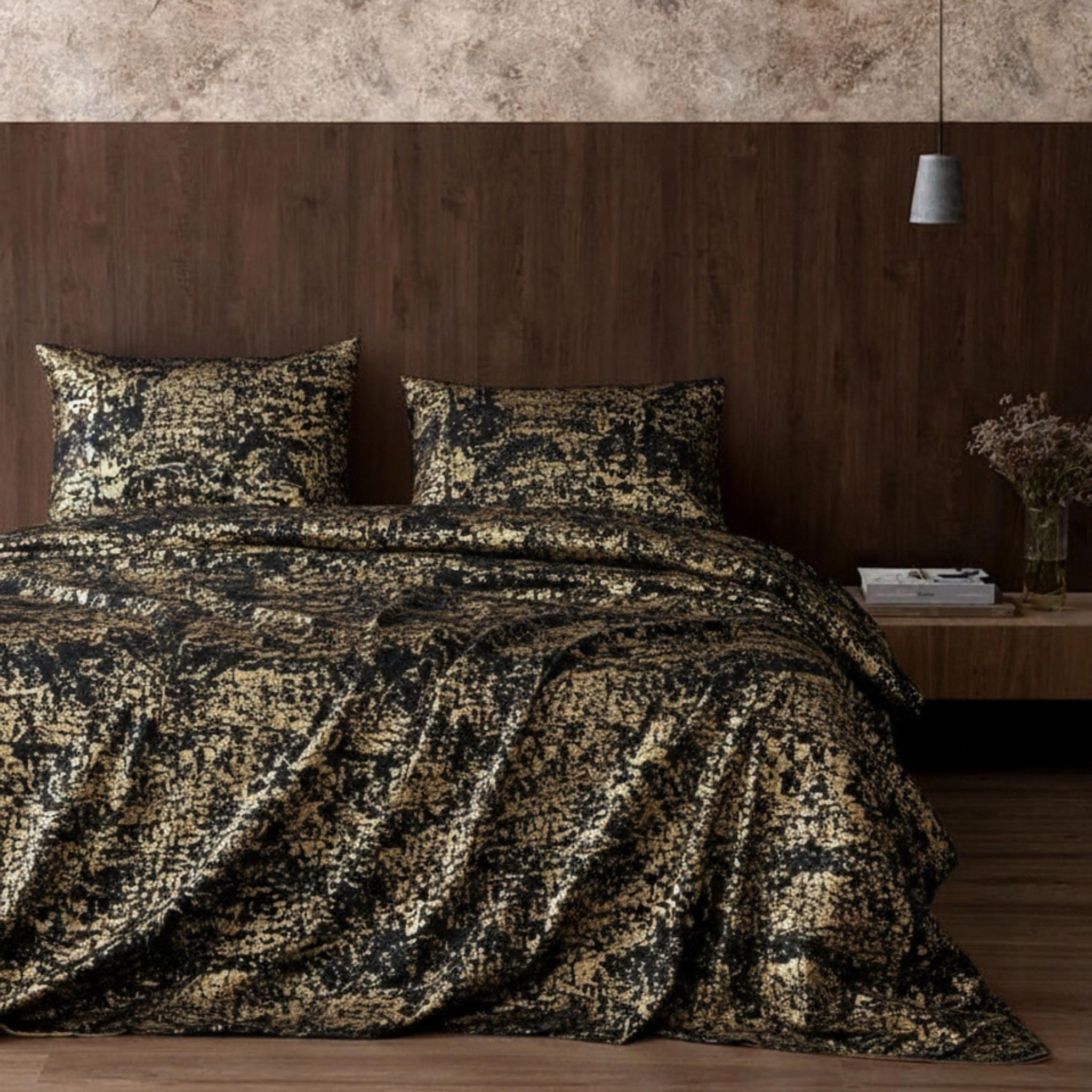 Black copper bedspread in dark bedroom