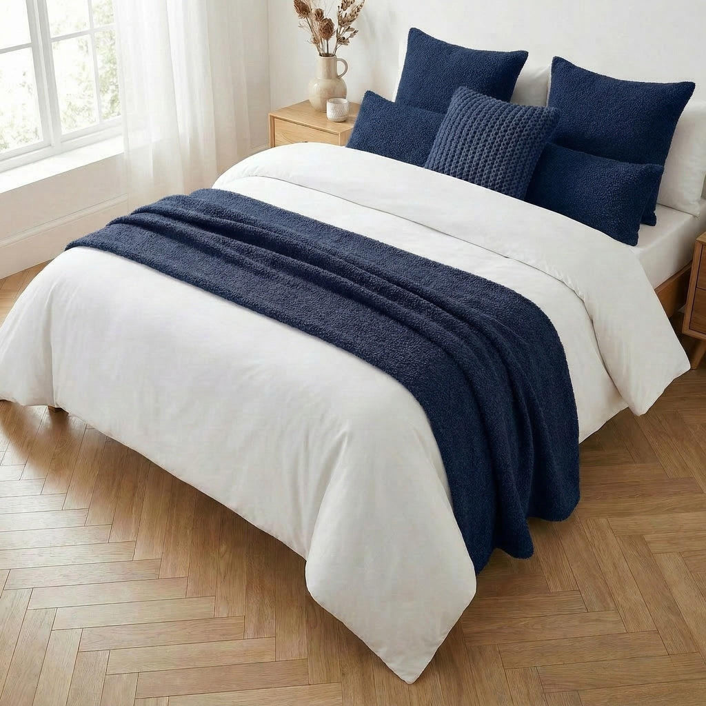 Navy bed runner on a styled bed