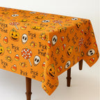 Orange Halloween tablecloth draped over a wooden table