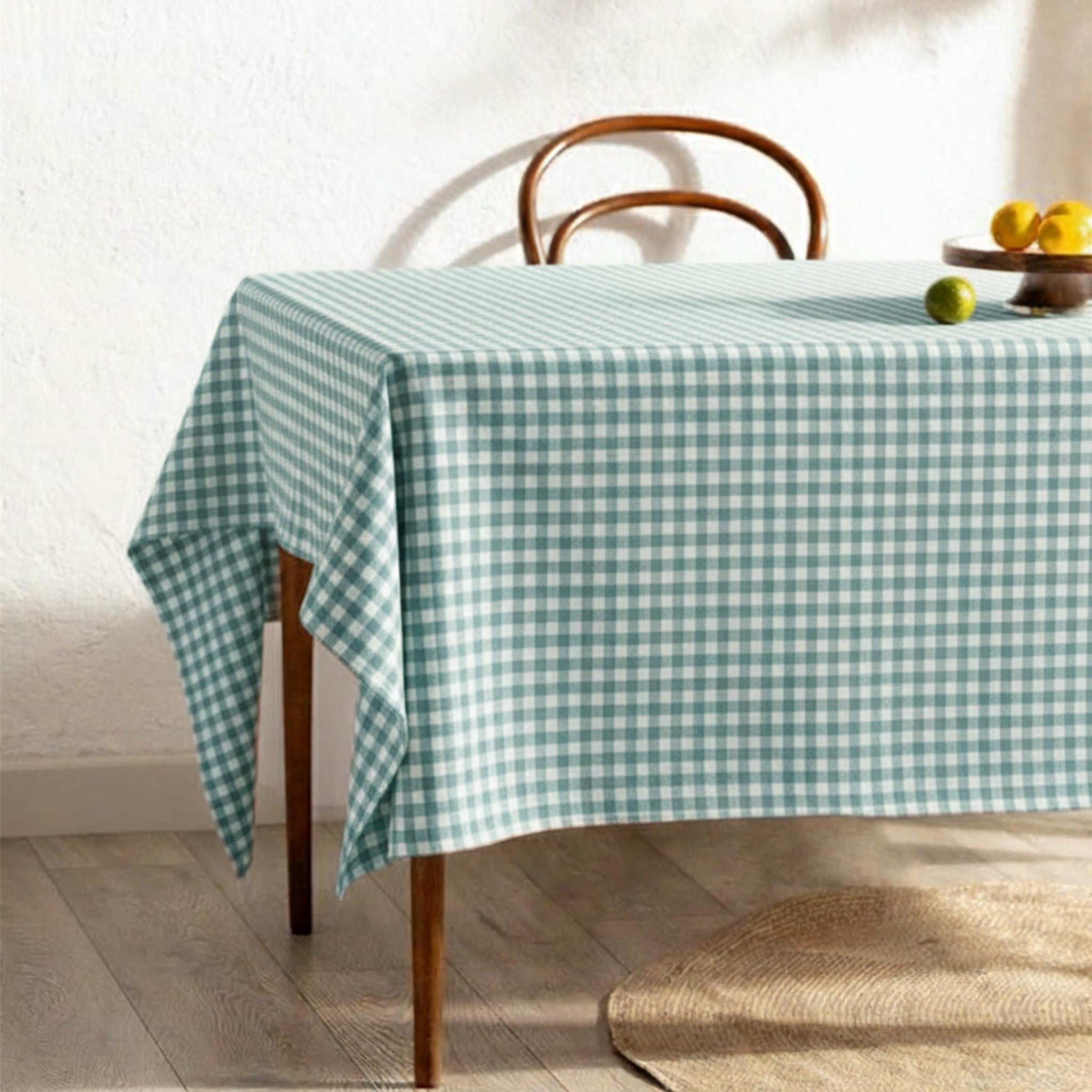 Mint green gingham cotton tablecloth on a sunlit breakfast table
