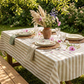 Beige striped cotton tablecloth on a farmhouse dining table