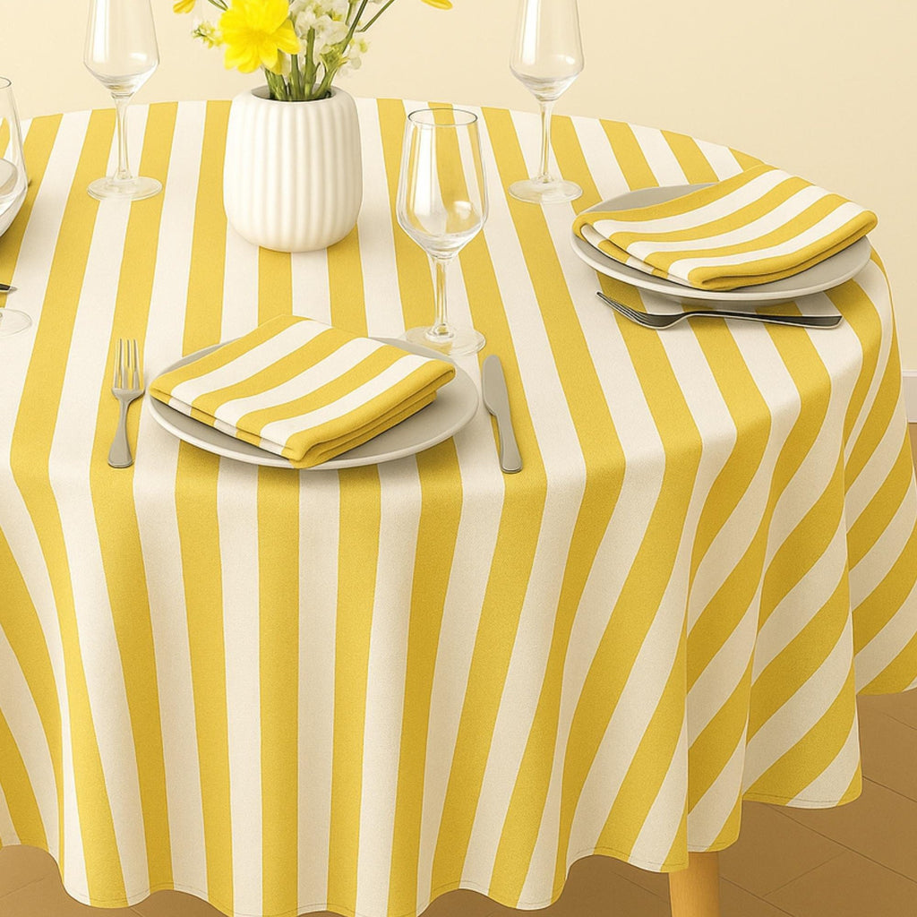 Yellow striped cotton tablecloth on a sunlit summer dining table