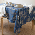 Navy blue velvet tablecloth with copper accents on an elegant dinner table