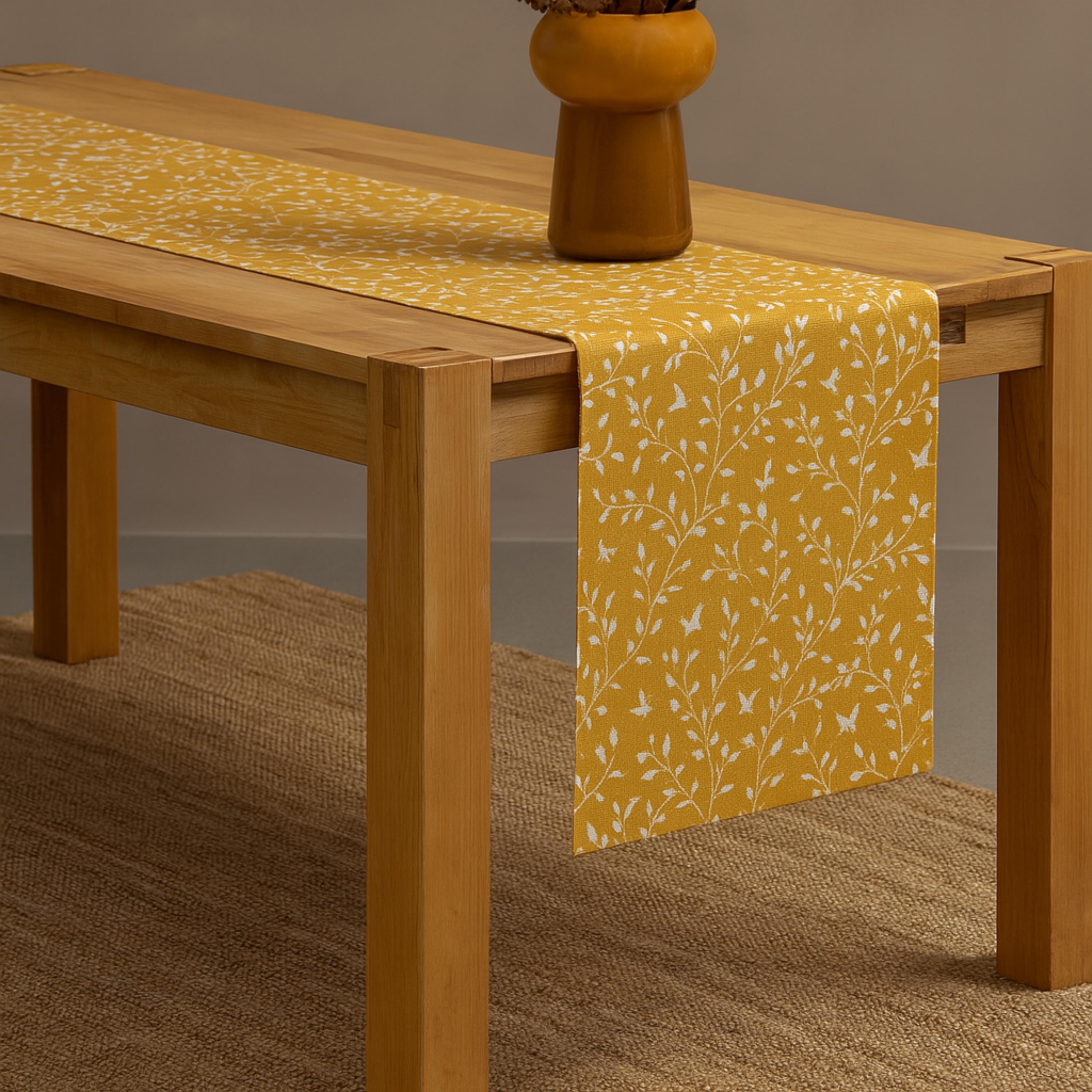Botanical cotton table runner draped over table
