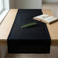 Black linen table runner on dining table