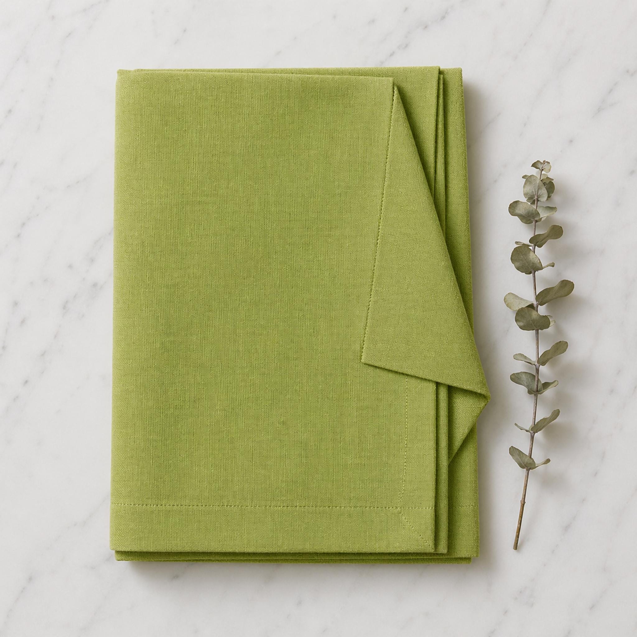 Folded green linen napkins detail