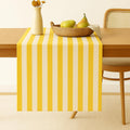 Yellow striped cotton table runner on dining table